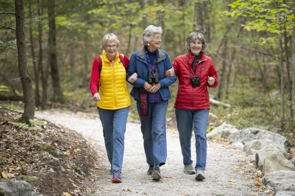 Three RiverWoods Durham Independent Living residents hiking the trails in Durham, New Hampshire