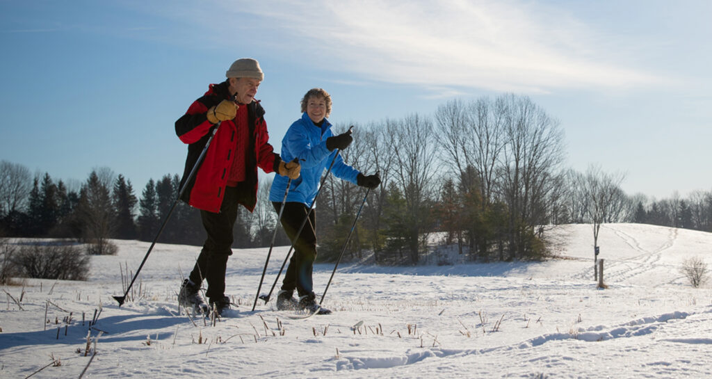 Two RiverWoods Durham Independent Living residents skiing in Durham, New Hampshire