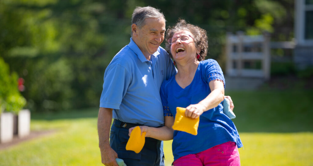Two RiverWoods Durham Independent Living residents playing cornhole in Durham, New Hampshire