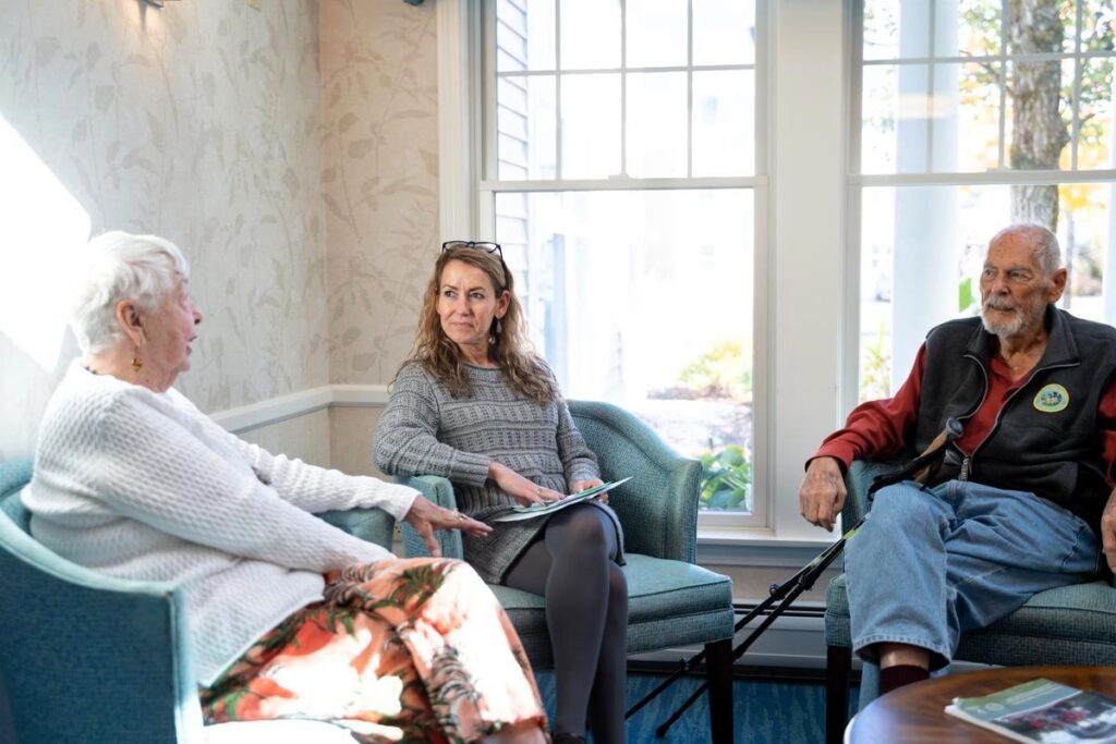 a couple talking with staff member of RiverWoods